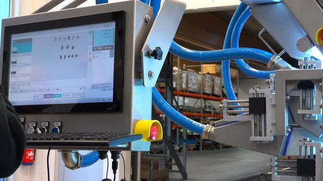 the specialist makes adjustments to the amber machine display.