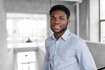 Fototapeta premium business and people concept - smiling african american businessman at office