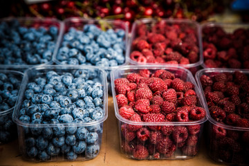 Berries on market stall / Blueberries, raspberries and cherries on marketplace 