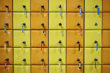 Series of colored, numbered lockers with locks, keys and tags.