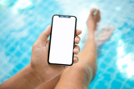 man at the pool holding phone with an isolated screen
