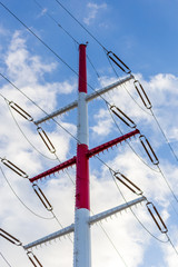 Red and white electric line pole.