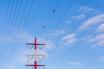 Red and white electric line pole.