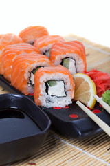 Salmon sushi rolls on a wooden background