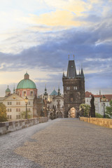Fototapeta na wymiar Beautiful view of Old Town Tower of Charles Bridge at dawn in Prague, Czech Republic