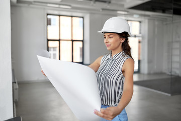 building, architecture and construction business concept - businesswoman or architect in helmet...