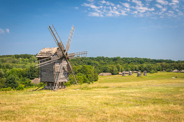 Fototapeta na wymiar Old wood windmill on a summer day