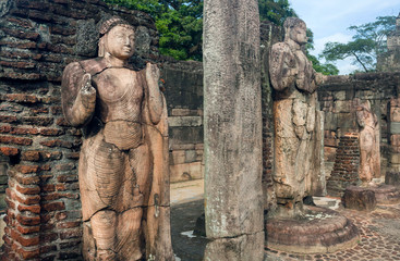 Fototapeta na wymiar Stone figure of standing Buddha in broken 12th century buddhist temple, Sri Lanka. Ancient town Polonnaruwa. UNESCO World heritage Site