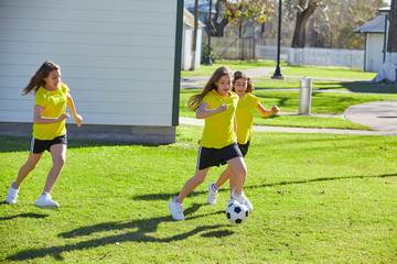Friend girls teens playing football soccer in a park