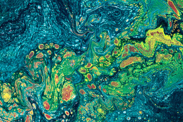 Marbling textured creative background. Mixing green, blue, yellow and red paints. Lines and...