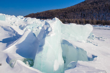 Ice near the forest on the lake 