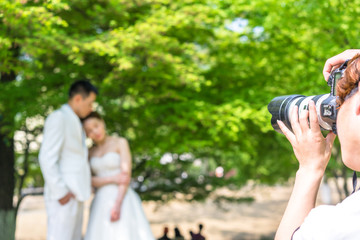 wedding photographer working with couple