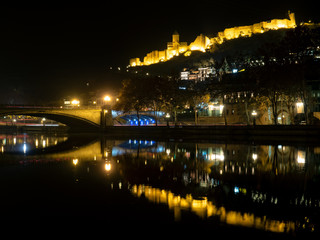 Fototapeta na wymiar Nariakala fortress reflected in Kura river by night, Tbilisi, Georgia