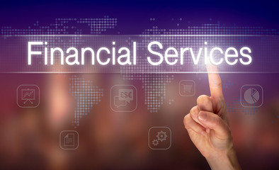A hand selecting a Financial Services business concept on a clear screen with a colorful blurred background.