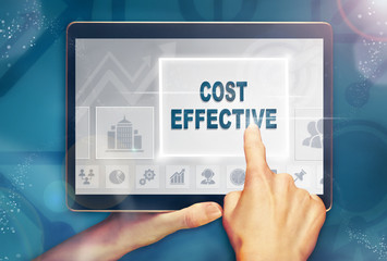 A hand selecting a cost effective business concept on a computer tablet screen with a colorful background.