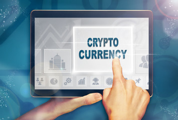 A hand selecting a crypto currency business concept on a computer tablet screen with a colorful background.