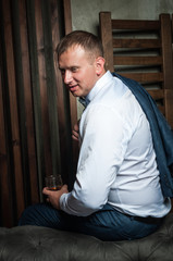 Luxury groom in a wedding suit in a beautiful interior room