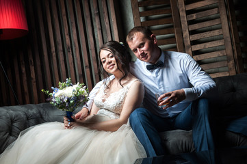 Young couple of the bride and groom in a beautiful interior room