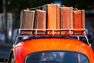 suitcases with things on the roof of the car