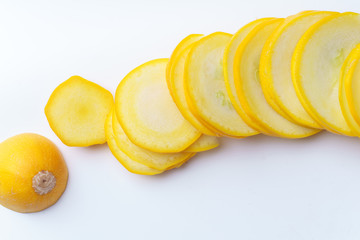 Sliced summer yellow squash on white background
