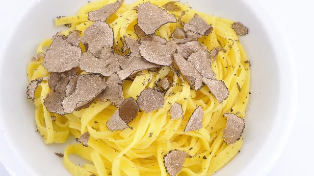 Delicious Italian fettuccine dish with black truffle. Top view, (loopable)