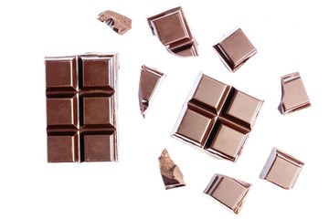 Chocolate cubes, pieces of bitter, dark chocolate bar, isolated on white background, top view