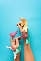Mental health concept. Colorful paper butterflies flying and sitting on womans hands. Harmony...