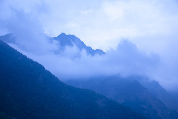 A beautiful mountain landscape, overlooking the height with clouds