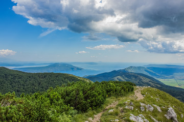 Naklejka premium perfect nature tropic scenery landscape of forest mountain ridge from above with view to the sea island and horizon lane