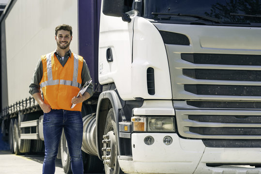 Worker standing in front of lorry