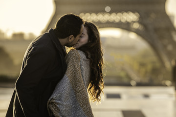 Couple kissing each other at Eiffel Tower