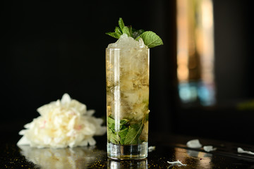 mohito (Mojito) drink coctail lemon ice fresh mint on table black background