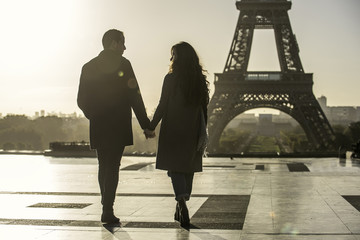 Couple walking towards Eiffel Tower