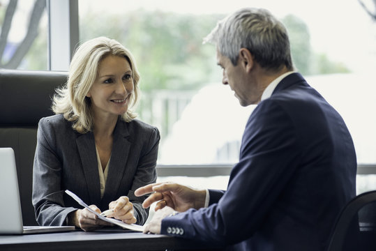 Business people discussing paperwork