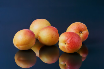 Ripe fresh apricots isolated on black background