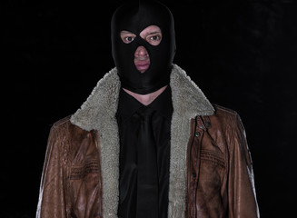 a man in a black mask on a black background