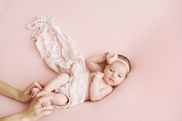 Newborn girl on a pink background. Photoshoot for the newborn. 7 days from birth. A portrait of a...