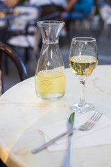 White wine in a liter bottle on a table in a cafe.