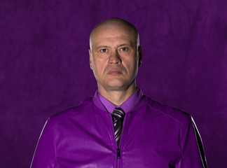 portrait of a bald man in a burgundy shirt