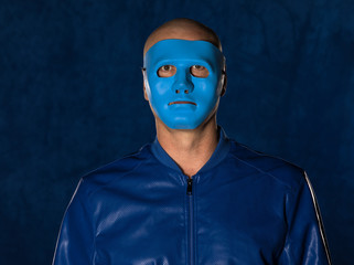 portrait of a man in a blue mask