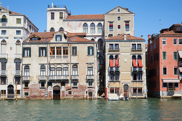Fototapeta na wymiar Venice buildings facades and canal in a sunny day in Italy, nobody