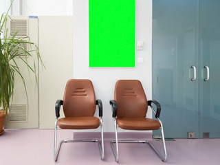 Waiting room in hsopital hall with a green screen board. Ready mock-up