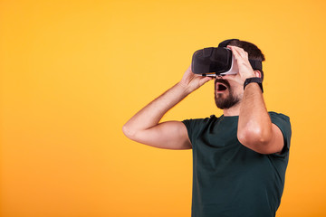 Man wearing VR virtual reality headset is amazed. Modern technology