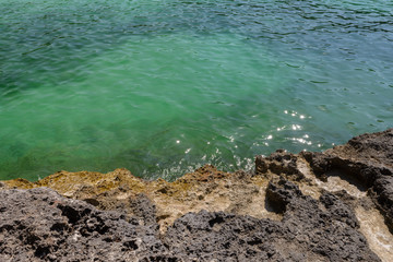 view of the beautiful sea water from the rocky shore