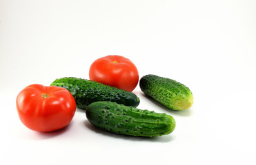 Ripe red tomatoes and cucumbers from the garden.