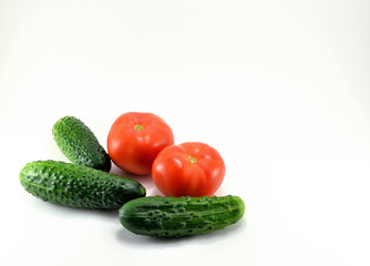 Ripe red tomatoes and cucumbers from the garden.