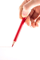 hand with the red pencil on a white background