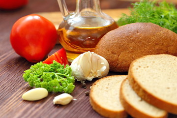 Variety of organic food including vegetables, spices, oil and bread