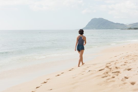 Woman walking in the beach on a sunny day