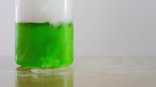 Bubbling green fluid in jar and smoke